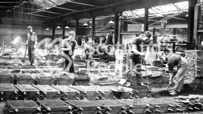Workmen lining moulds at Carron Works, 20th century