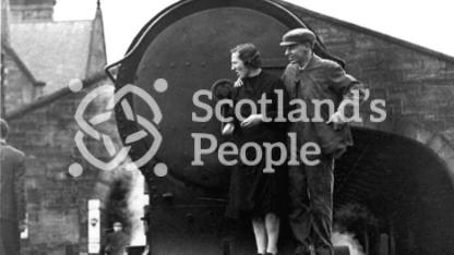 Couple on front footplate of locomotive, 1943