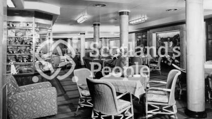 The Third Class Garden Lounge looking to port on board the Cunard Line ocean liner RMS Queen Mary