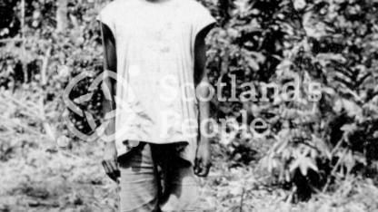 Cameroonian in a clearing in the jungle with a camp fire