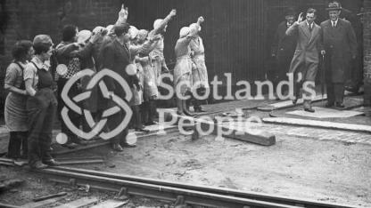 A group of workers greeting HRH Prince George on his visit to the Carron Works