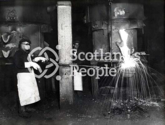 Workmen filling ladle at Carron Works, 20th century
