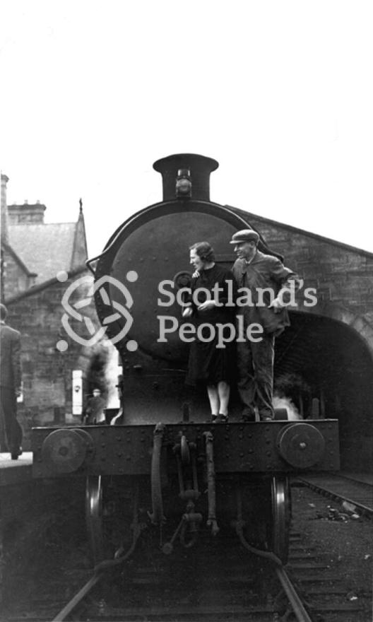 Couple on front footplate of locomotive, 1943