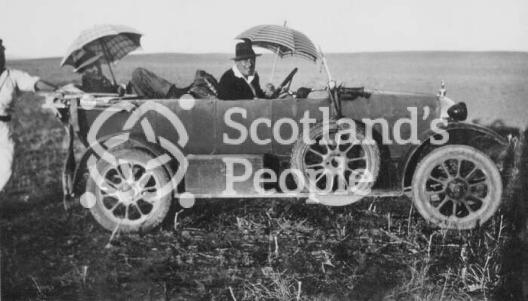 Robert Stewart-Peter in his motor car 'Florrie' with 'Fanny Adams' near Mosul, Northern Iraq, 1926
