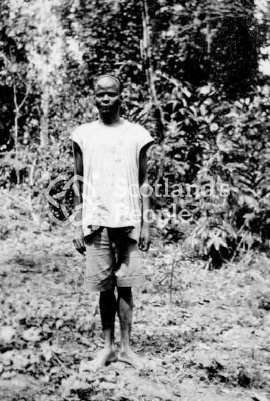 Cameroonian in a clearing in the jungle with a camp fire