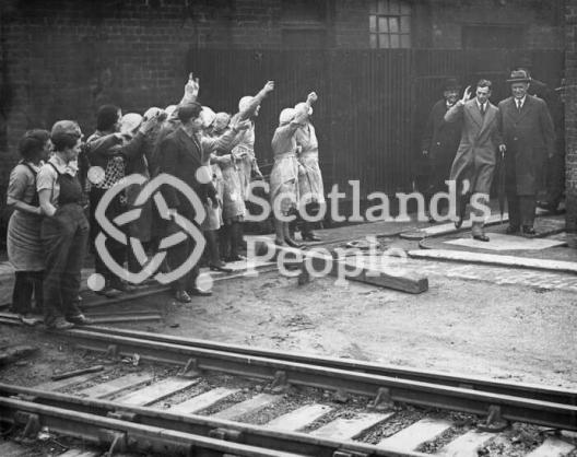 A group of workers greeting HRH Prince George on his visit to the Carron Works