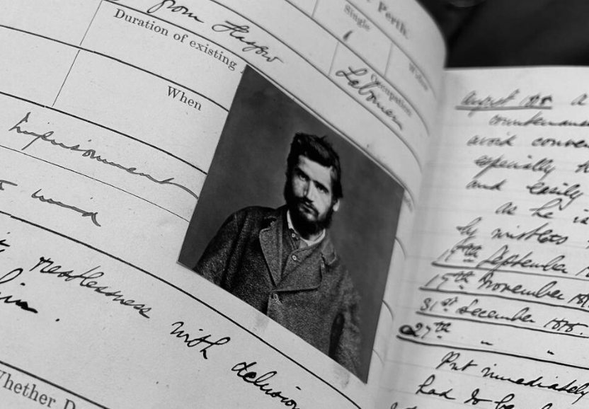 Photograph of Perth prison register showing image of patient and handwritten notes.